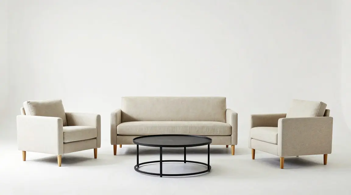 beige upholstered sofa set with armchairs and round black coffee table