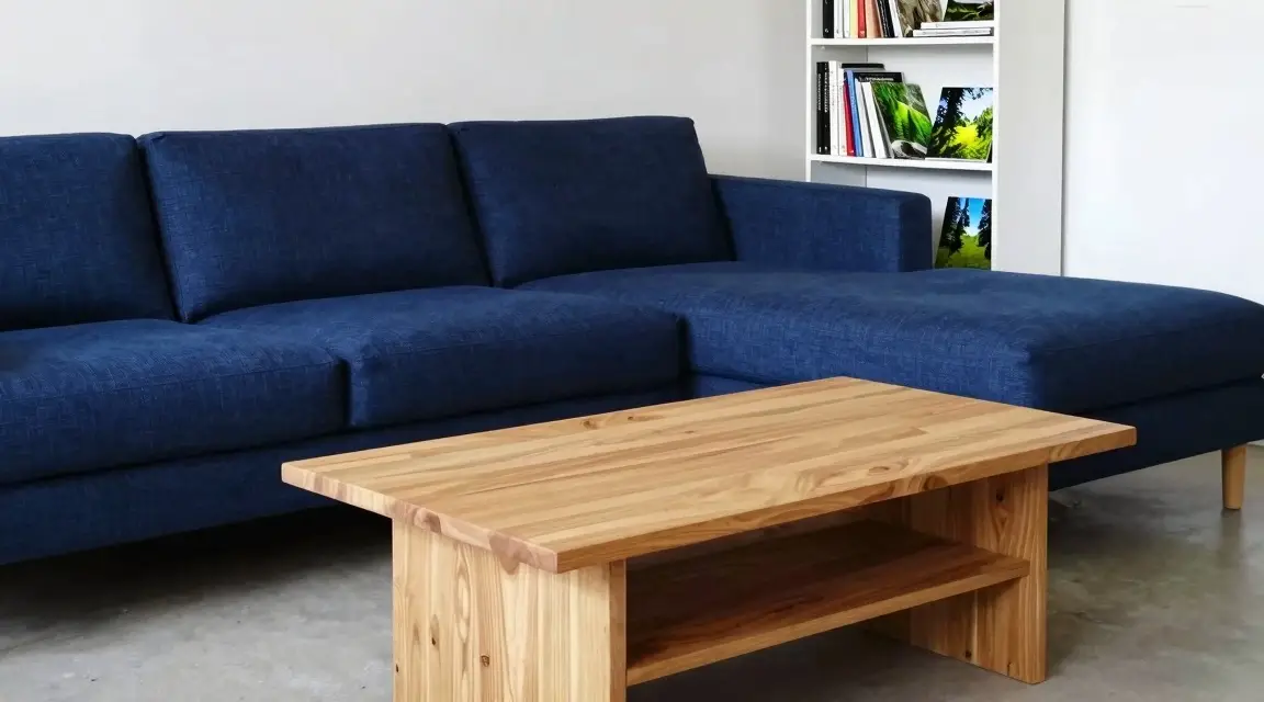 dark blue modular sofa and light wood coffee table in a cozy room